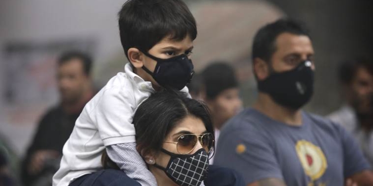 A boy sits on the shoulder of his mother as they participate in a protest against air pollution in New Delhi, India, Sunday, Nov. 6, 2016. Even for a city considered one of the worlds dirtiest, the Indian capital hit a new low this week. Air so dirty you can taste and smell it; a gray haze that makes a gentle stroll a serious health hazard. According to one advocacy group, government data shows that the smog that enveloped the city midweek was the worst in the last 17 years. (AP Photo/Manish Swarup)
