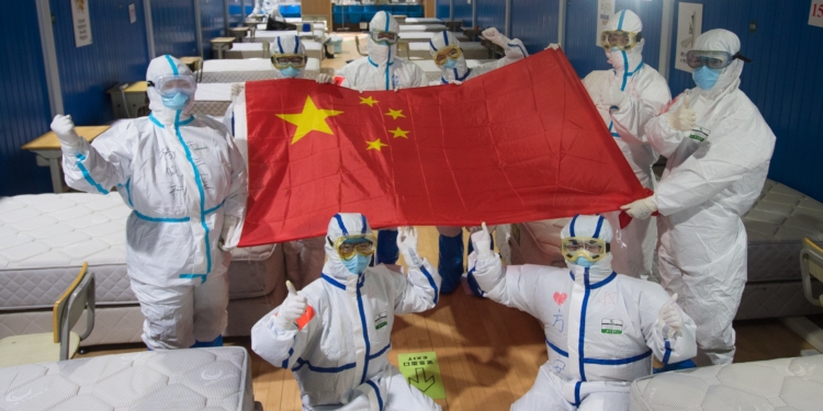 (200311) -- WUHAN, March 11, 2020 (Xinhua) -- Medical workers pose for photos after seeing cured patients off at the Wuchang temporary hospital in Wuhan, central China's Hubei Province, March 10, 2020.
  The last two temporary hospitals in Wuhan, the epicenter of the coronavirus outbreak in central China's Hubei Province, were shut down Tuesday, marking the closure of all 16 temporary hospitals in the city. (Xinhua/Xiao Yijiu)