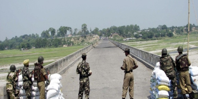 Indian border guards stand guard at the India-Nepal border in Ranigunge, about 40 km (24.9 miles) from the northeastern Indian city of Siliguri, May 30, 2007. Thousands of refugees in Nepal protested on the Indian frontier as border guards stopped them from crossing into India on their way to their birthplace in Bhutan. The protests came after Bhutan held its second "mock election" this week as a dress rehearsal for the kingdom's transition to democracy in 2008 after a century of royal rule. The refugees have demanded their right to return to their birthplace to vote.  REUTERS/Stringer (INDIA) - RTR1Q9A2