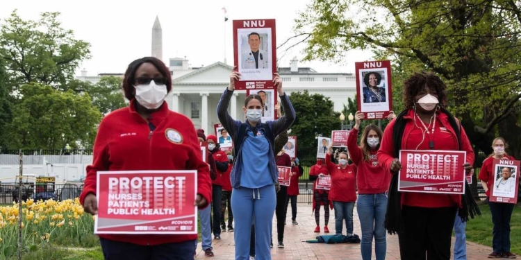 Nurses protest against the lack of personal protection equipment amid the covid-19 pandemic in front of the White House in Washington, DC, on April 21, 2020. (Photo by NICHOLAS KAMM / AFP)